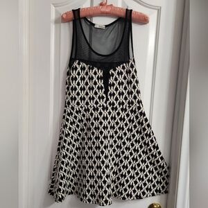 black and white patterned skater-style dress with a mesh top